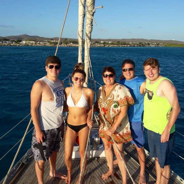 a group of people standing next to a body of water