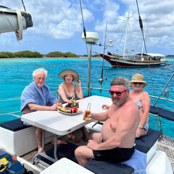 a group of people sitting in a boat on a body of water