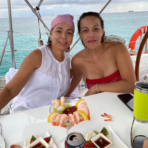 a man and a woman sitting on a boat in the water