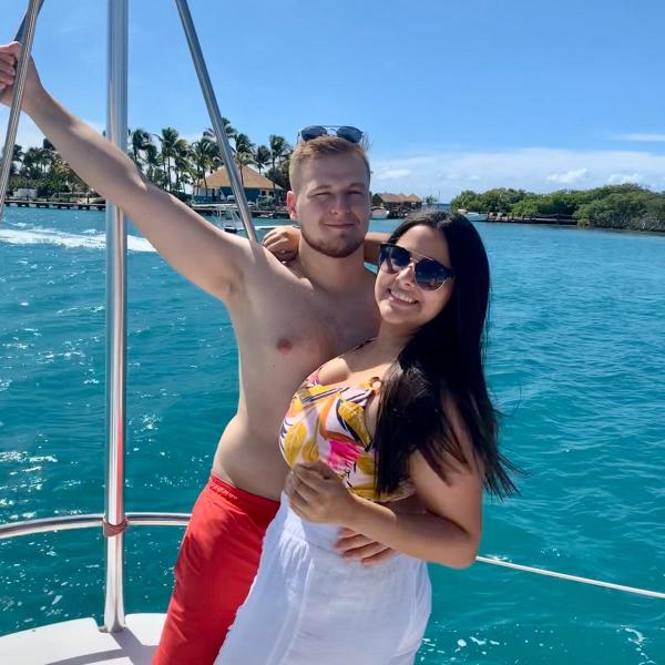 a woman standing next to a body of water