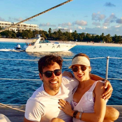 a person sitting on a dock next to a body of water